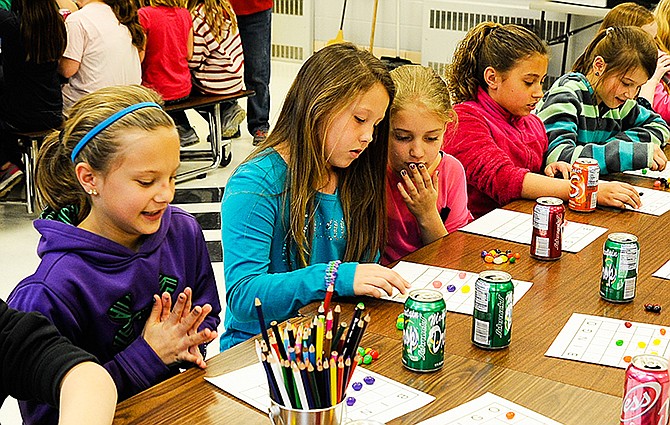 Playing jelly bean bingo recently at Eugene Elementary School, students were serious and enthusiastic about lining up their treats for a larger prize as part of a reading success celebration.