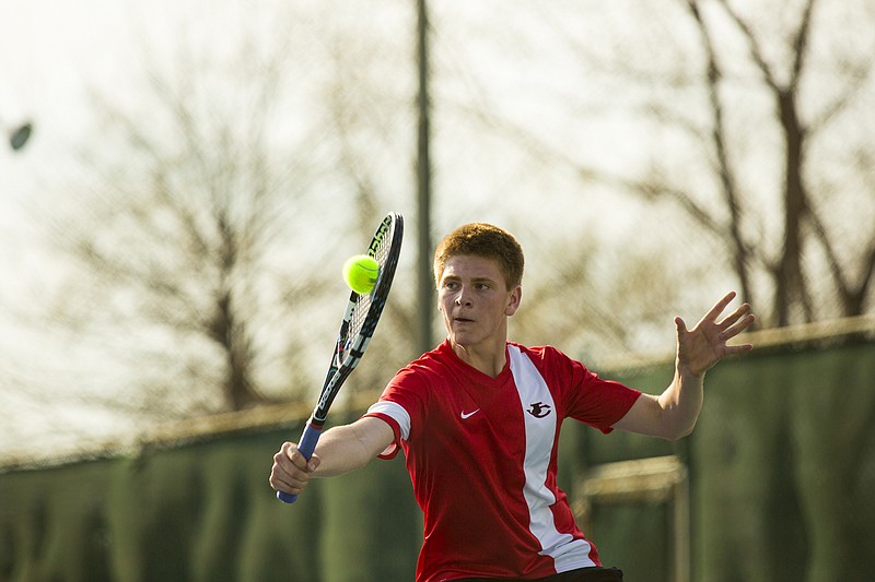 Jefferson City's David Clausen punches a backhand volley during the Jays' win against Marshall on Thursday at Washington Park.