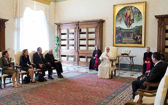 In this photo released by Vatican newspaper L'Osservatore Romano, Pope Francis meets members of the International Catholic Child Bureau, at the Vatican Friday, April 11, 2014. Pope Francis asked for forgiveness Friday from people who were sexually abused by priests, and vowed that there will be no going back in the church's fight to protect children. 