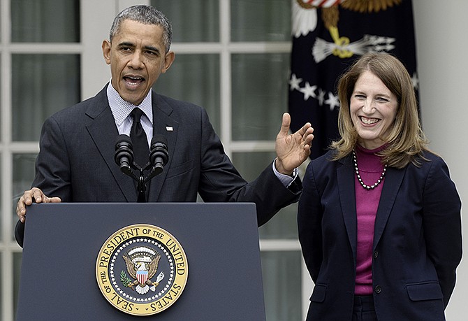 President Barack Obama, stands with his nominee to become Health and Human Services secretary, Budget Director Sylvia Mathews Burwell, while speaking Friday in the Rose Garden of the White House.