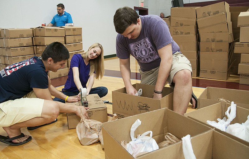 Abbie Gutmann, vice-president of school and service for William Woods University's Greek Life, tapes a box full of non-perishable foods for the North and Central Missouri Food Bank's Buddy Pack Program. Students organized about 4,000 pounds of food into bags which were then packed into the boxes. William Woods students raised $2,224 during the school's Greek Week for the Buddy Pack program.