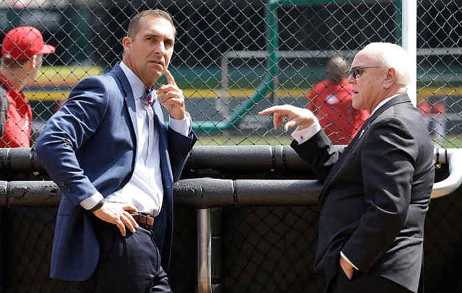 St. Louis Cardinals general manager John Mozeliak, left, talks with Cincinnati Reds general manager Walt Jocketty during batting practice prior to their opening day baseball game, Monday, March 31, 2014, in Cincinnati. 