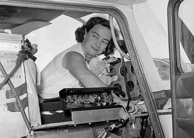 This photo made April 16, 1964, shows Jerrie Mock checking her extra gas tank cap just before taking off from Oakland Airport, in Oakland, California. Fifty years ago the 38-year-old Columbus, Ohio, housewife became the first woman to fly solo around the world.