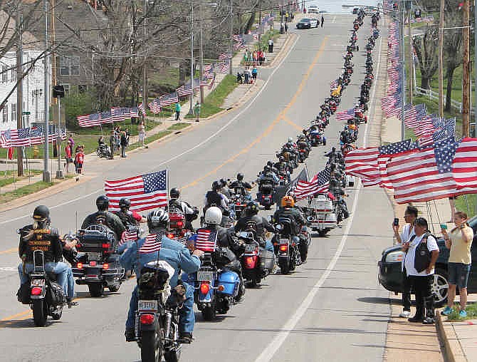 Members of the Rolla Patriot Guard Riders travel along the procession route on 10th Street in Rolla, Mo., after the funeral service of Sgt. Timothy Owens, 37, of Effingham, Ill., Saturday, April 12, 2014. Owens was a soldier killed in shootings at Fort Hood, Texas, earlier this month. 