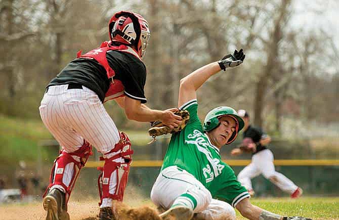 Jefferson City catcher Jackson Walker tags out Blair Oaks' Logan Gratz as Gratz tries to steal home Saturday morning during the Jays' win over Blair Oaks at the Capital City Invitational.