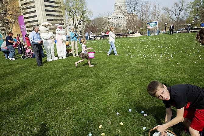 Kids swarm the open field full of easter eggs moments after Governor Jay Nixon announced the start of the Easter Egg Hunt at the Governor's Mansion.