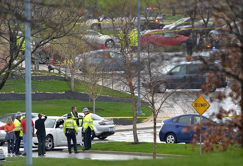 Kansas state troopers stand near the location of a Sunday shooting at the Jewish Community Center in Overland Park, Kan.