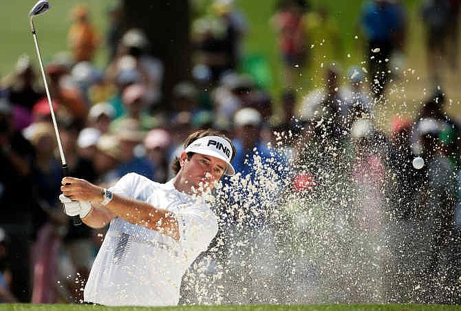 Bubba Watson hits out of a bunker on the seventh hole during the fourth round of the Masters golf tournament Sunday, April 13, 2014, in Augusta, Ga. 