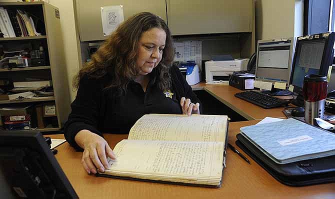 Robin Blevins, support services supervisor for the Cole County Sheriff's Department, has been collecting photos, documents and newspaper articles regarding the history of the department.