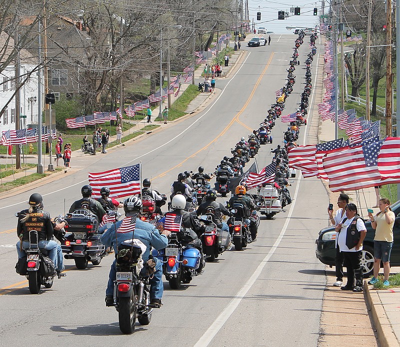 Members of the Rolla Patriot Guard Riders travel along the procession route after the funeral service of Sgt. Timothy Owens.