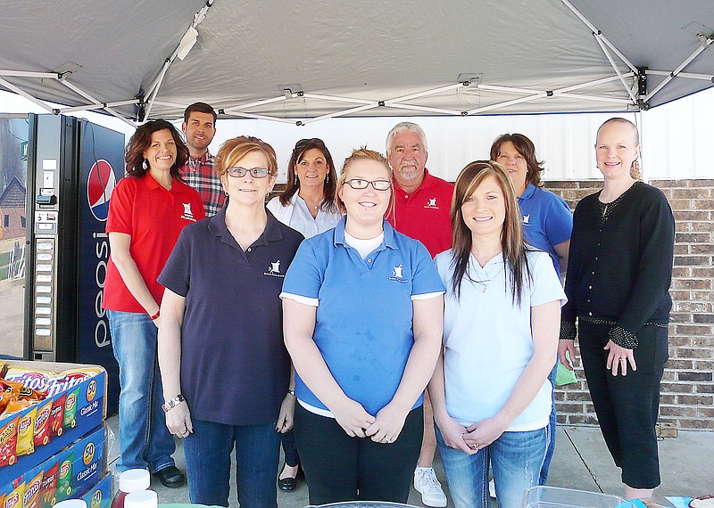 The Bond Pharmacy team were serving hotdogs, chips and sodas to customers Friday in honor of 25 years in business.  The team includes, front row, left to right, Colene Volkart, Torrey Geiger and Leslie Bolinger; back row, Amanda Trimble, Brian Hills, Sandy Bond, Ward Bond, Angie Weber and Melanie Lawson.
