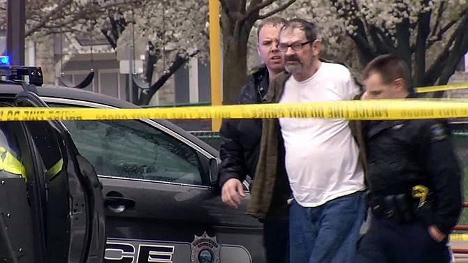 In this image from video provided by KCTV-5, Frazier Glenn Cross, also known as Frazier Glenn Miller, is escorted by police in an elementary school parking lot in Overland Park, Kan. Cross, 73, is accused of killing three people in attacks at a Jewish community center and Jewish retirement complex.