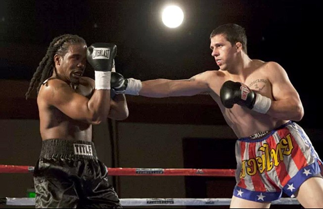 Alex White, right, hits opponent Jeff Combs during White's boxing debut in February. A professional mixed martial arts fighter, White has signed a UFC contract to take on Estevan Payan this Saturday on FOX Sports 1.