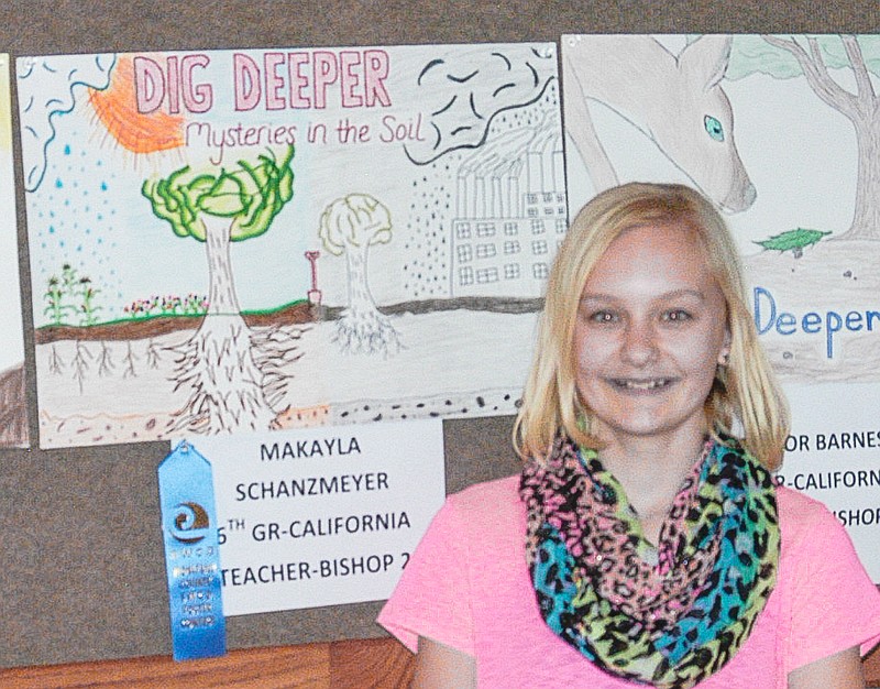 Sixth grader Makayla Schanzmeyer with her overall sixth grade winning poster.