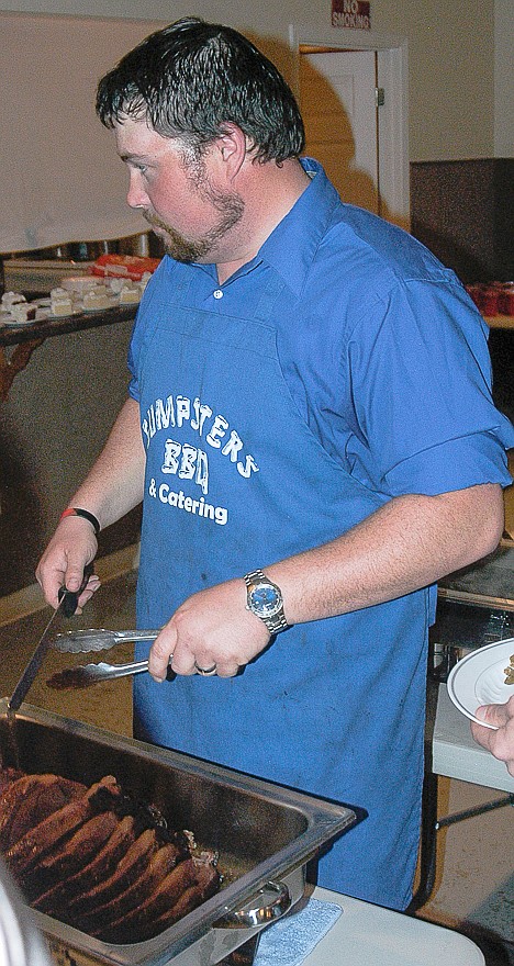 Scott Emmerick, with Gumpsters BBQ and catering, serves prime rib to the attendees at the CPI "Wine, Dine and Win" event Saturday, April 12.