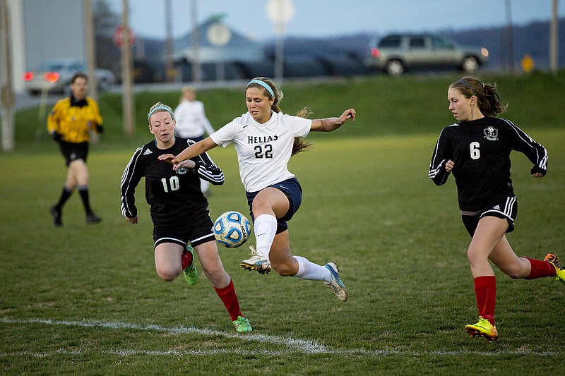 Helias' Maddie Lammers takes to the air while trying to control the ball during Tuesday's game with Hannibal.