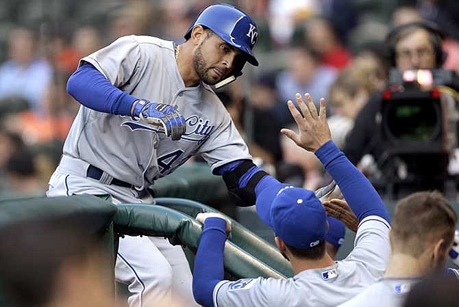 Kansas City Royals' Omar Infante, left, is welcomed into the dugout after hitting a solo home run against the Houston Astros in the first inning of a baseball game Tuesday, April 15, 2014, in Houston.
