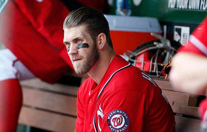 Washington Nationals' Bryce Harper sits on the bench during the fourth inning of a baseball game against the St. Louis Cardinals at Nationals Park on Saturday, April 19, 2014, in Washington. The Cardinals won 4-3. Harper was pulled early from a game after Washington manager Matt Williams said the young outfielder didn't hustle. Harper was taken out after six innings. The 21-year-old Harper is a two-time All-Star known for his aggressive play. But in the sixth inning, he hit the ball to the mound, jogged to first and took a right turn to the dugout before getting halfway down the basepath. 