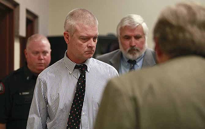 Craig Michael Wood, left, enters the courtroom for a hearing Wednesday, March 26, 2014, in Springfield, Mo. Wood, who was a middle school football coach, is charged with first-degree murder, armed criminal action and child kidnapping in connection with 10-year-old Hailey Owens' death. 