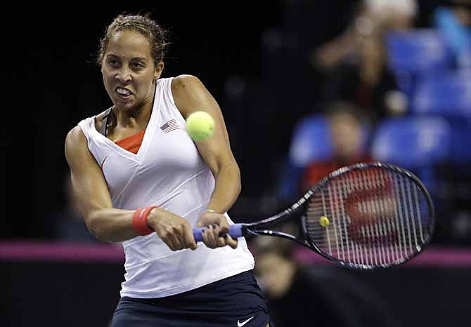 United States' Madison Keys returns the ball to France's Alize Cornet during a Fed Cup singles world group playoff tennis match Saturday, April 19, 2014, in St. Louis. Keys defeated Cornet 6-7 (4), 7-6 (4), 6-3.