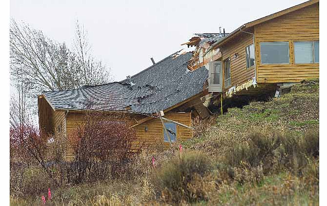 A house breaks apart as a slow-moving landslide in Jackson, Wyo. advances downhill on Friday, April 18. 2014. The slide has cut off access to a 60-person neighborhood and has threatened town utilities, including a water line.