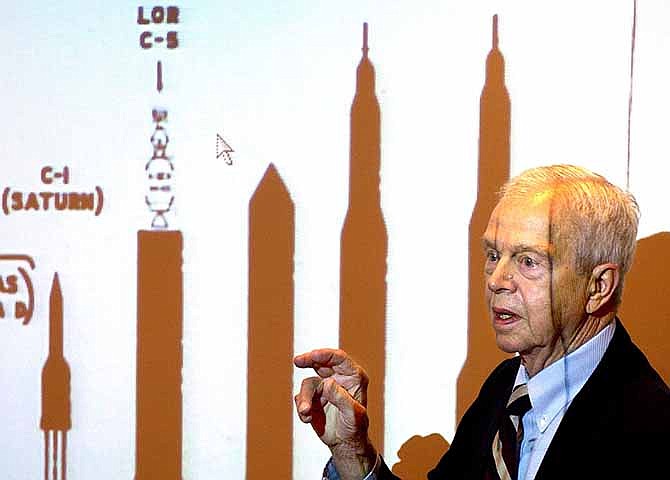 This Oct. 9, 2003, file photo shows John C. Houbolt explaining the size of different rockets required to launch various methods for landing on the moon at Grainger Engineering Library in Urbana, Ill. Houbolt, an engineer whose contributions to the U.S. space program were vital to NASA's successful moon landing in 1969, has died. He was 95.