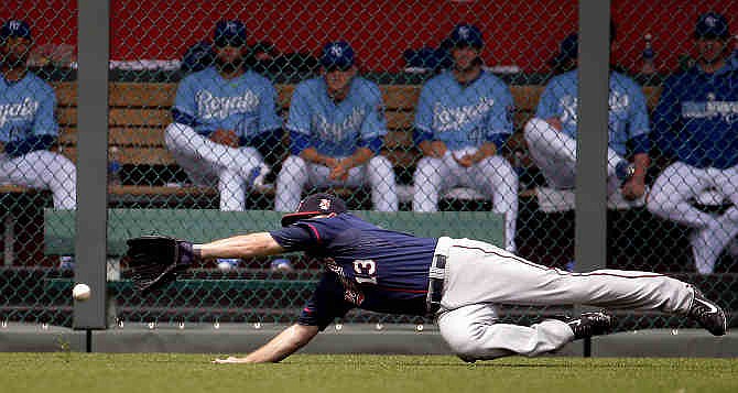 Minnesota Twins' Jason Kubel dives for a double hit by Kansas City Royals' Justin Maxwell during the second inning of a baseball game on Sunday, April 20, 2014, at Kauffman Stadium in Kansas City, Mo. 