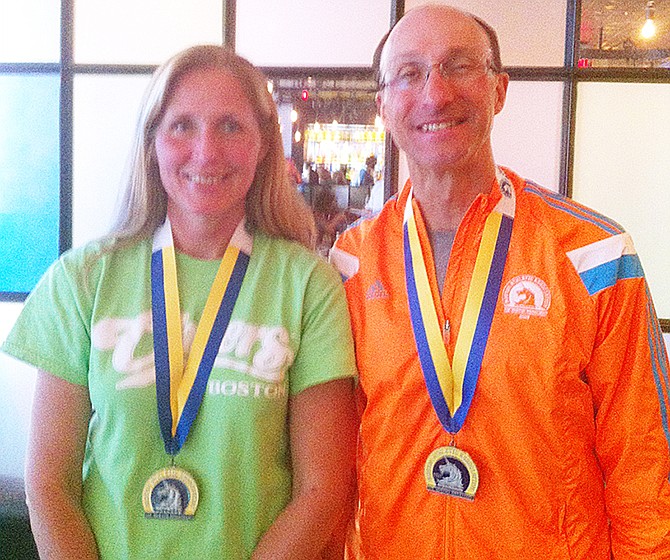 Patty Burmeister and fellow Jefferson Citian Dana Frese stand together after completing the Boston Marathon.