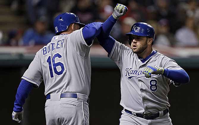 Kansas City Royals' Mike Moustakas (8) celebrates his three-run home run with Billy Butler in the third inning of a baseball game against the Cleveland Indians on Tuesday, April 22, 2014, in Cleveland. 