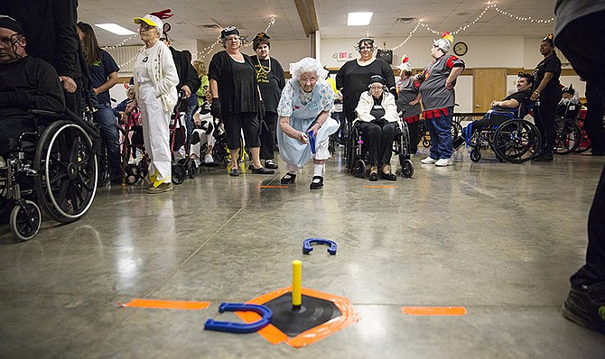 Thelma Black tries her hand at the horseshoe toss during the Golden Age Games.
