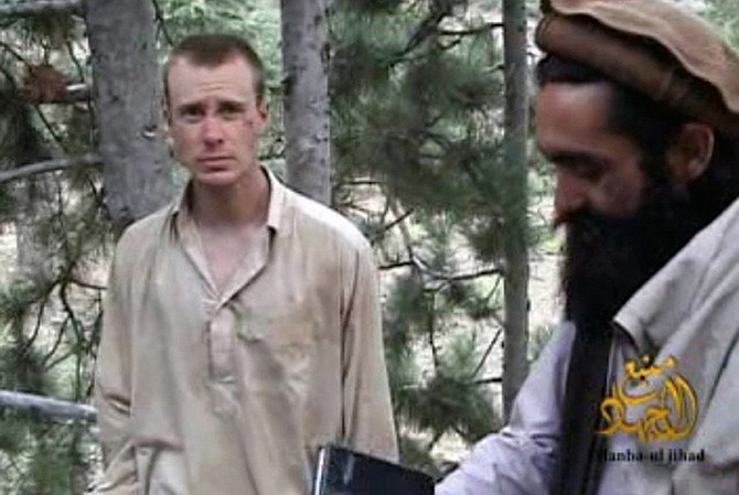 This 2010 IntelCenter image shows a frame grab from a video released by the Taliban containing footage of a man believed to be Sgt. Bowe Bergdahl, left.
