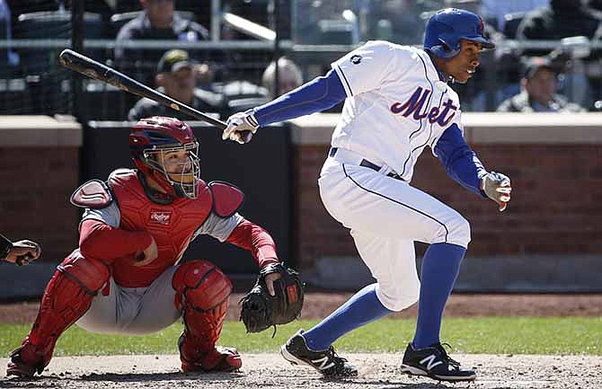 New York Mets pinch-hitter Curtis Granderson watches his seventh-inning RBI single in the Mets' 4-1 victory over the St. Louis Cardinals in a baseball game in New York, Thursday, April 24, 2014.