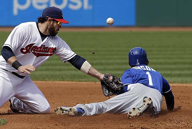 Kansas City Royals' Jarrod Dyson (1) steals second as the ball gets away from Cleveland Indians second baseman Jason Kipnis in the third inning of a baseball game Thursday, April 24, 2014, in Cleveland. 