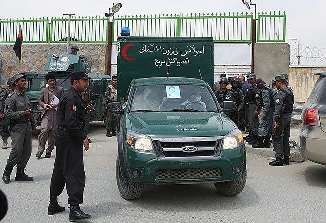 An Afghan police ambulance leaves the Cure International Hospital in Kabul, Afghanistan on Thursday. The U.S. embassy in Afghanistan says three American doctors were killed by an Afghan security guard who opened fire at a hospital in Kabul. 
