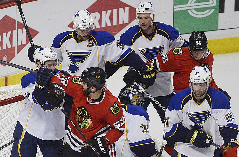 Members of the Chicago Blackhawks and St. Louis Blues tangle in front of the Blues' net during Wednesday night's Game 4 in Chicago.