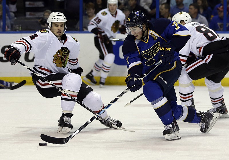  St. Louis Blues' T.J. Oshie, right, slips past Chicago Blackhawks' Niklas Hjalmarsson, of Sweden, on his way to score during the second period in Game 5 of a first-round NHL hockey playoff series Friday, April 25, 2014, in St. Louis.
