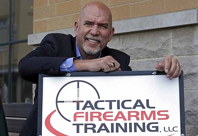 In this photo taken on Friday, April 18, 2014, Guy Relford, an attorney specializing in gun rights, poses outside his law office in Carmel, Ind. Redford is also the owner and instructor at Tactical Firearms Training teaching firearm safety as well as a comprehensive Indiana gun law course.