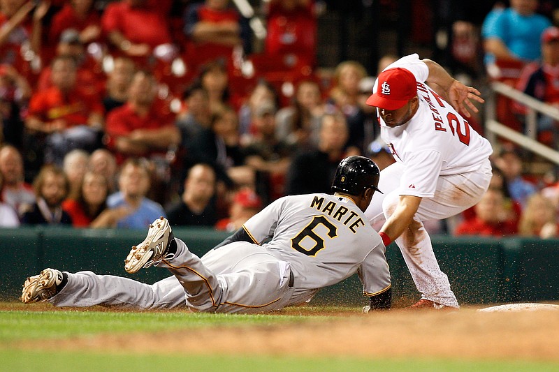 Pittsburgh Pirates' Starling Marte (6) is tagged out by St. Louis Cardinals shortstop Jhonny Peralta after getting caught in a rundown during the eighth inning of a baseball game on Friday, April 25, 2014, in St. Louis.