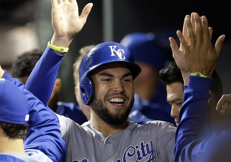 Kansas City Royals' Eric Hosmer high-fives teammates in the dugout after scoring on a single by Alex Gordon in the first inning of a baseball game against the Baltimore Orioles, Friday, April 25, 2014, in Baltimore.