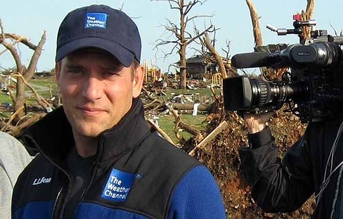 This 2011 image released by the Weather Channel shows meteorologist Mike Bettes at the scene of a tornado in Joplin, Mo. 