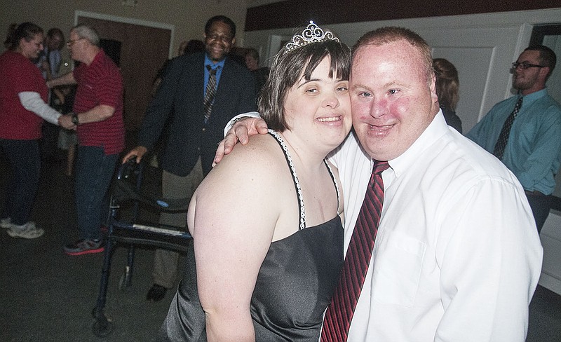 Katie Stinson of Kingdom City and her date Joey Garrard smile for a photo during a prom sponsored by the organization, Celebrating Abilities Together (CAT), at the John C. Harris Community Center. CAT organizes dances at the community center once a month for people of all ages with developmental (physical or mental) disabilities. The dances allow parents and caregivers to network while allowing those with disabilities a chance to feel comfortable and welcomed in a social setting. Stinson, 22, was prom queen of North Callaway High School and graduated from there in 2010. When Garrard was a high schooler, his school did not sponsor a prom, so Friday's dance was his first time attending a prom.