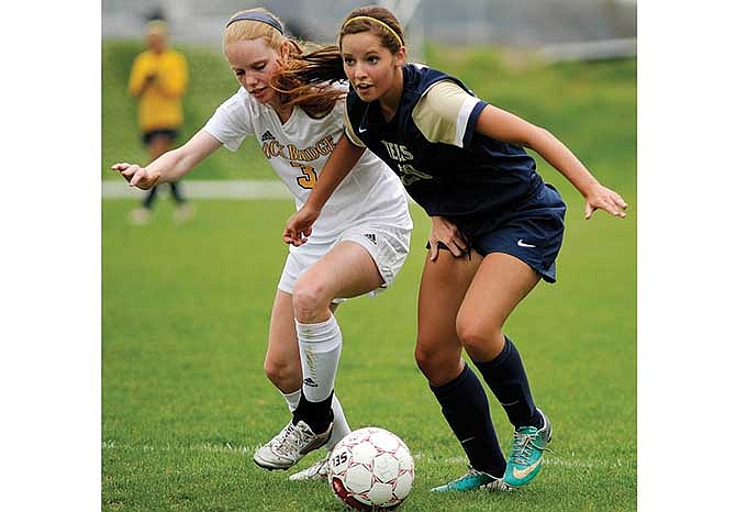 Helias' Janie McCurren (right) and Rock Bridge's Melissa Lowery fight for possession of the ball during Saturday morning's game at the 179 Soccer Park in Jefferson City.