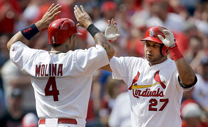 St. Louis Cardinals' Jhonny Peralta, right, is congratulated by teammate Yadier Molina after hitting a three-run home run during the sixth inning of a baseball game against the Pittsburgh Pirates, Sunday, April 27, 2014, in St. Louis.