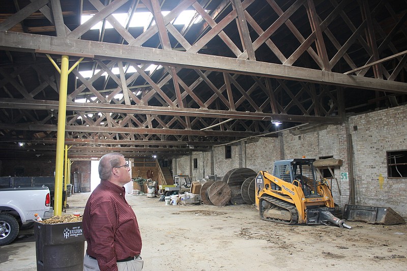 Fulton Director of Administration Bill Johnson looks at a mishmash of new and old wood beams and trusses in the city garage at its current warehouse complex. About 65 years of use and exposure have necessitated repairs to the aging structure every few years, Johnson said.