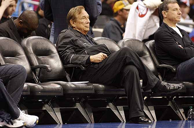 In this April 4, 2010, file photo, Los Angeles Clippers owner Donald Sterling sits courtside during the NBA basketball game between the New York Knicks and the in Los Angeles. NBA Commissioner Adam Silver Silver announced Tuesday, April 298, 2014, that Sterling has been banned for life by the league, in response to racist comments the league says he made in a recorded conversation.