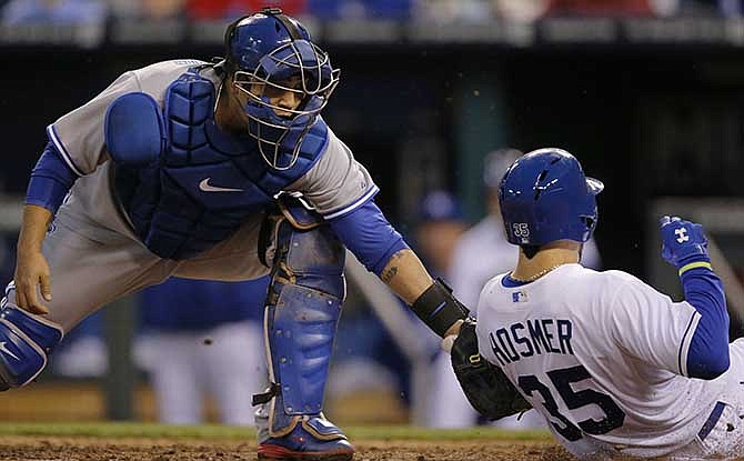 Toronto Blue Jays catcher Dioner Navarro, left, tags out Kansas City Royals' Eric Hosmer (35) during the fourth inning of a baseball game at Kauffman Stadium in Kansas City, Mo., Wednesday, April 30, 2014.