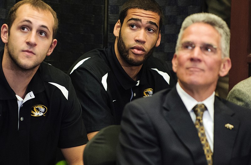 Missouri players Ryan Rosburg and Keanau Post, along with athletics director Mike Alden listen Tuesday as Kim Anderson speaks after he was introduced as the new head men's baskeetball coach in Columbia.