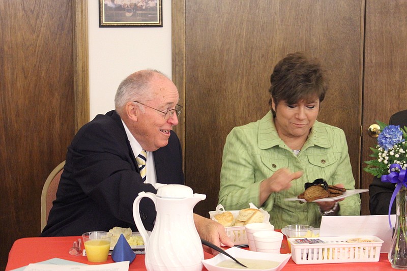 Mayor LeRoy Benton passes the gravy as Peggy Kirkpatrick helps herself to sausage during the 2014 Mayor's Prayer Breakfast Thursday morning. The annual Callaway County Senior Center fundraiser was moved to May 1 this year to coincide with the National Day of Prayer.