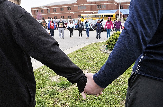 In this May 1, 2014 photo, more than 30 staff members and students from Thomas Jefferson Middle School took part in the Prayer at the Pole as part of activities celebrating the National Day of Prayer.