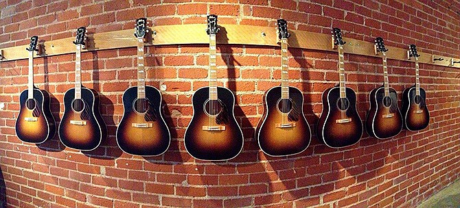 The Gibson guitars built using original wood from folk singing legend Woody Guthrie's 1860s-era boyhood home are on display in the Gibson Brands Beverly Hills, Calif., showroom. 